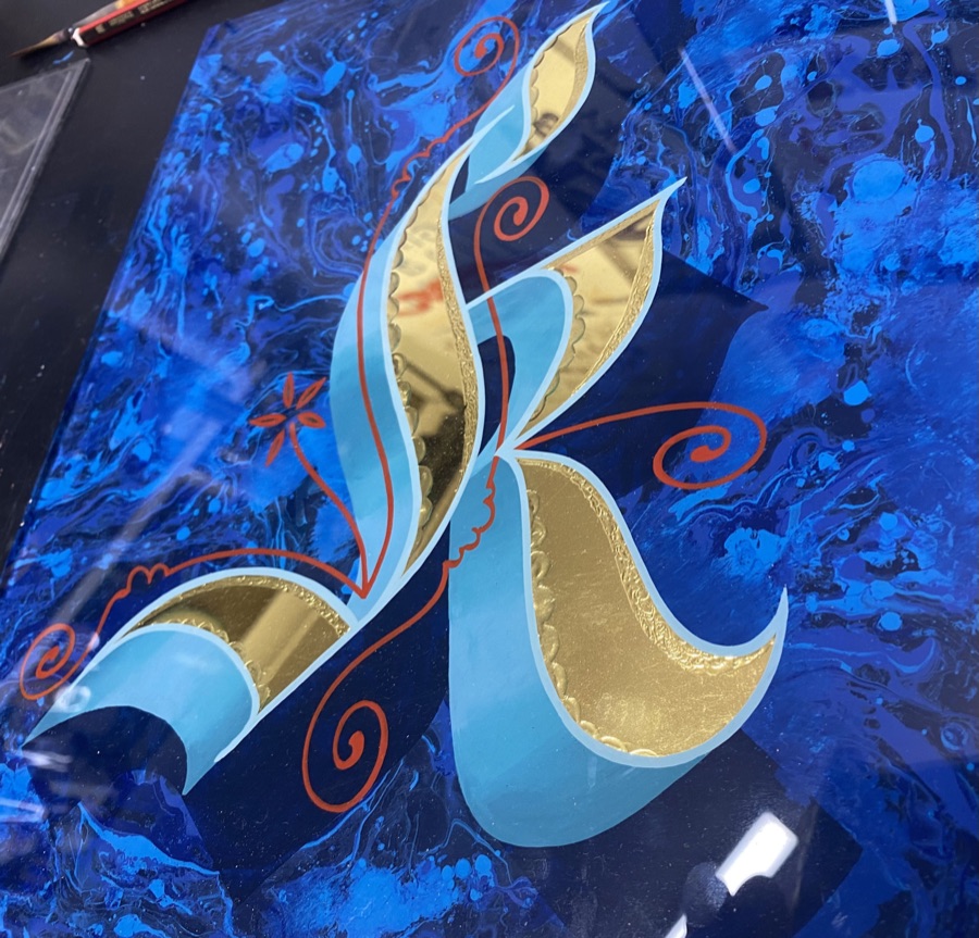 Gilded and painted letter R on glass
