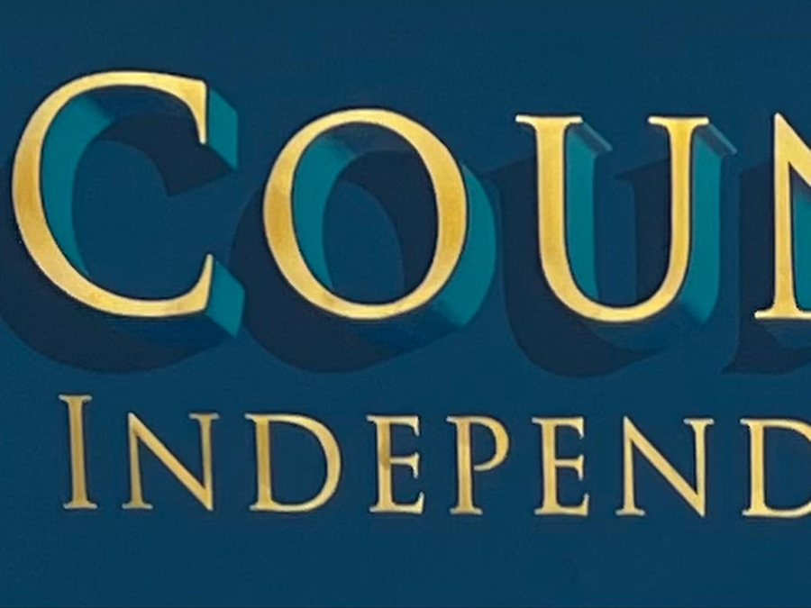 County Independent lettered in gold leaf with a teal shade on a dark blue panel