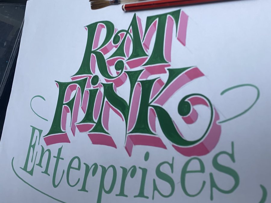 A hand-lettered &lsquo;Rat Fink Enterprises&rsquo; panel in shaded script and block lettering